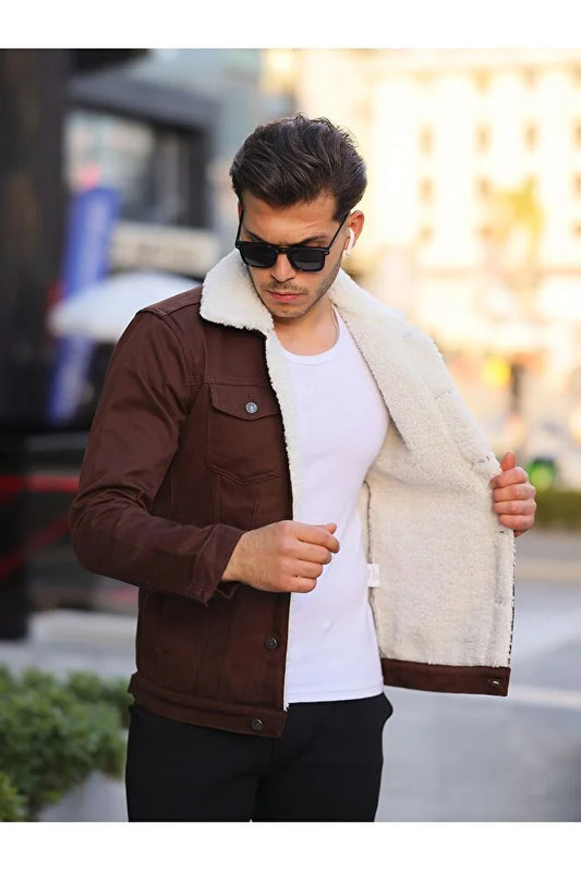 Man wearing a brown jacket with a white fur lining on a city street.