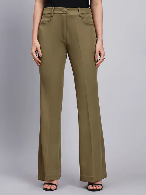 Person wearing olive green pants on a gray background