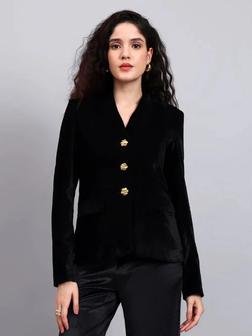 Close up black velvet fabric gold buttons premium stitching women pantsuit
